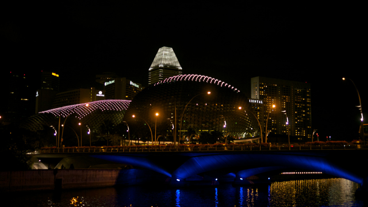 Looking over the river in Singapore at the illuminated city.