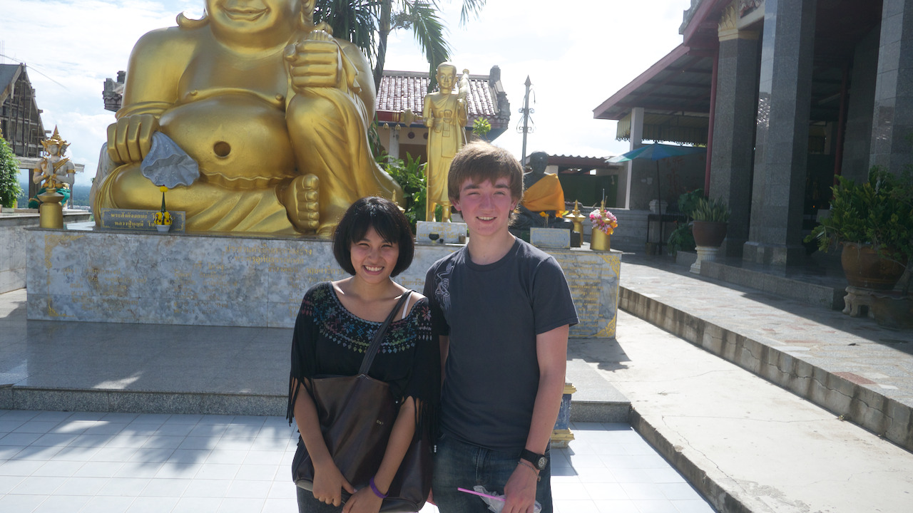 Me and Pear standing in front of a gold Buddha statue at the top.