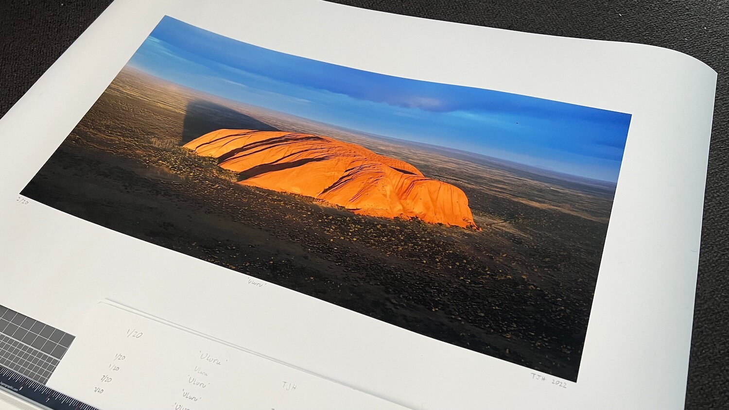 A picture of a photographic print of Uluru, Australia.